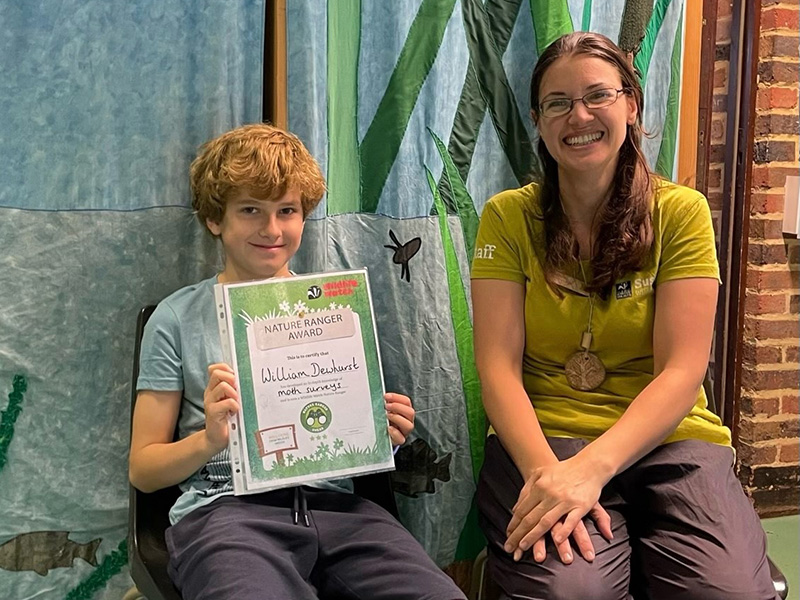 William receiving his Nature Ranger award from Communities and Wildlife Officer, Katie Parker William receiving his Nature Ranger award from Communities and Wildlife Officer, Katie Parker